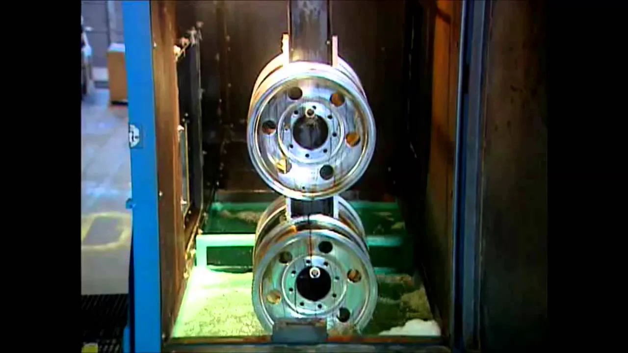Coated aluminum wheels fixtured for Kolene Recover paint stripping